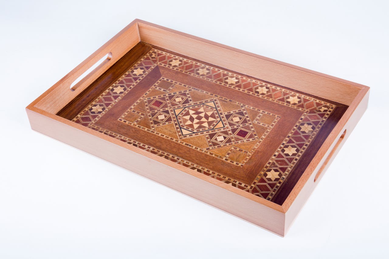Elegant handcrafted wooden tray featuring detailed inlaid patterns. Perfect for decor or serving.